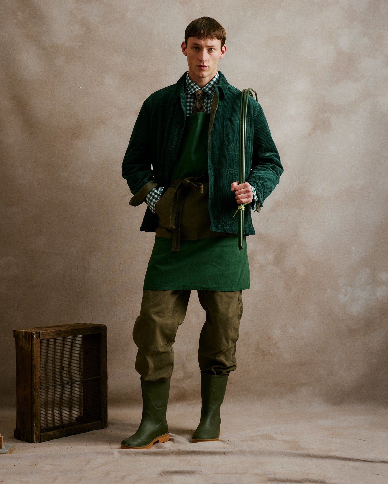 ChatGPT said:
Rovi Lucca FW24 Orto Botanico – Padded garden jacket in 100% cotton corded velvet and twill in Lovat and Bottle, lined with 100% polyester nylon in Lovat, paired with Lovat 100% cotton twill garden pants. Shirt in 100% cotton flannel, Bottle and Panna vichy pattern, with a contrasting Khaki and Panna vichy pocket, finished with a 100% Shetland wool neck tie. Garden apron in 100% cotton canvas with pockets and adjustable tie in Bottle and Lovat.