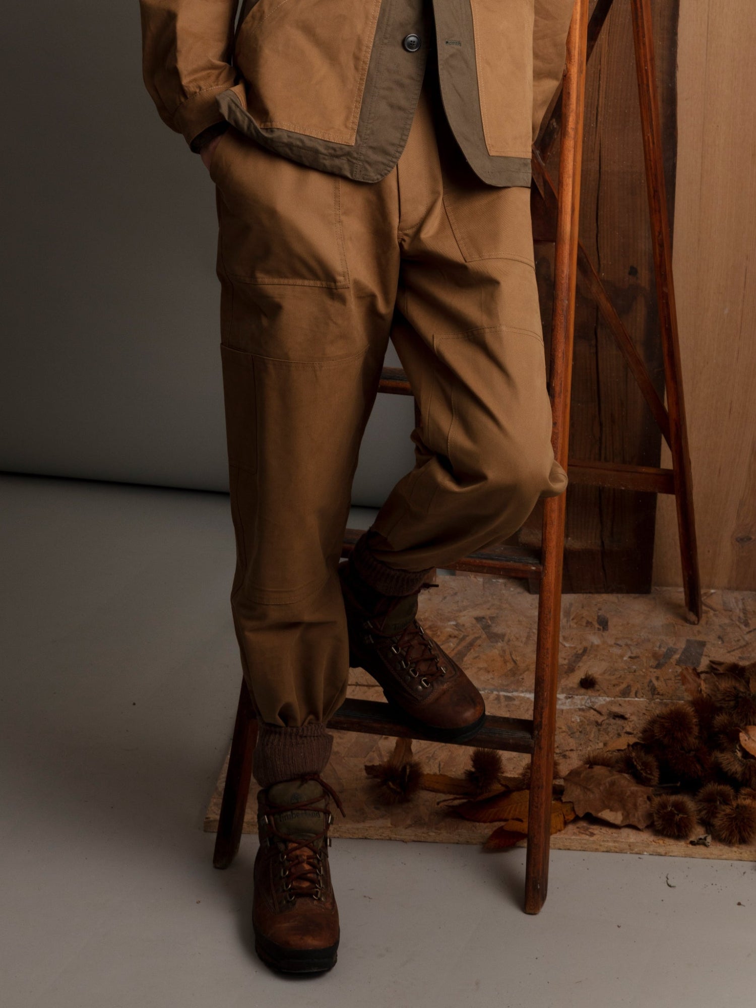 Drab khaki Garden Pants in 100% cotton twill with utility pockets, drawstring waist, and button-zip closure, made in Italy.”